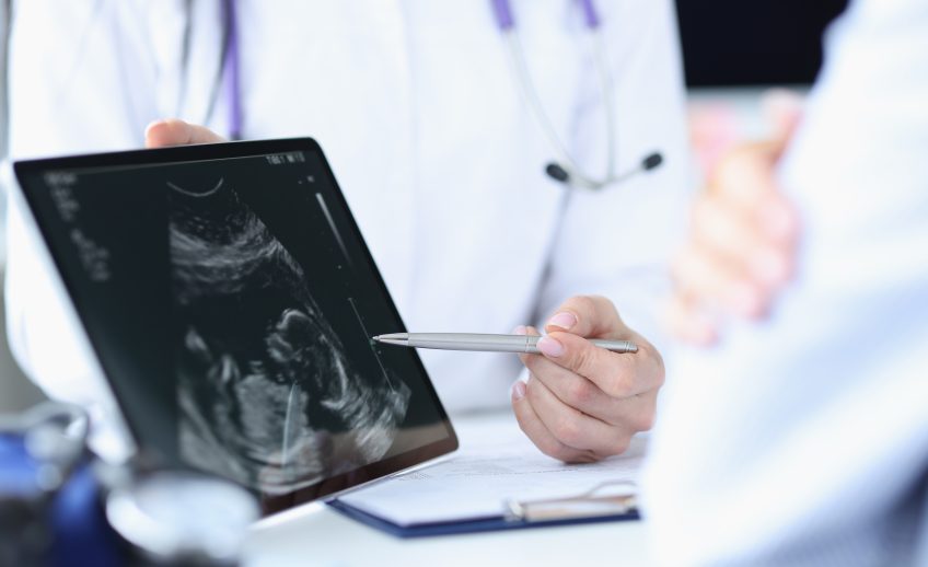Doctor,Demonstrates,Fetal,Ultrasound,On,Tablet,Screen.,Medical,Examination,During